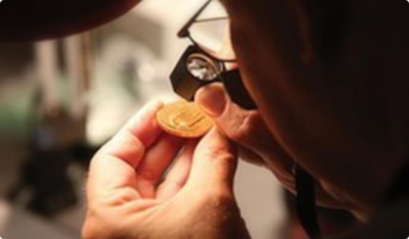 man inspecting a coin