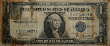 old one dollar bill with tape on it
