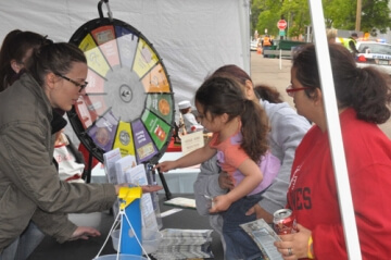 young girl spinning prize wheel