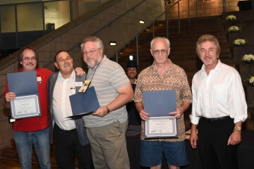 multiple men with awards
