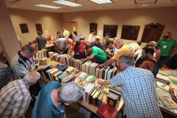 room full of people looking at books on shelves