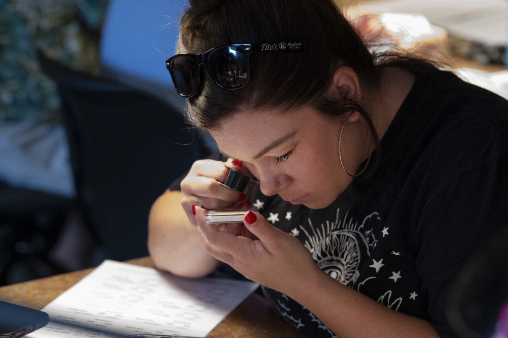 Woman Studying Coin